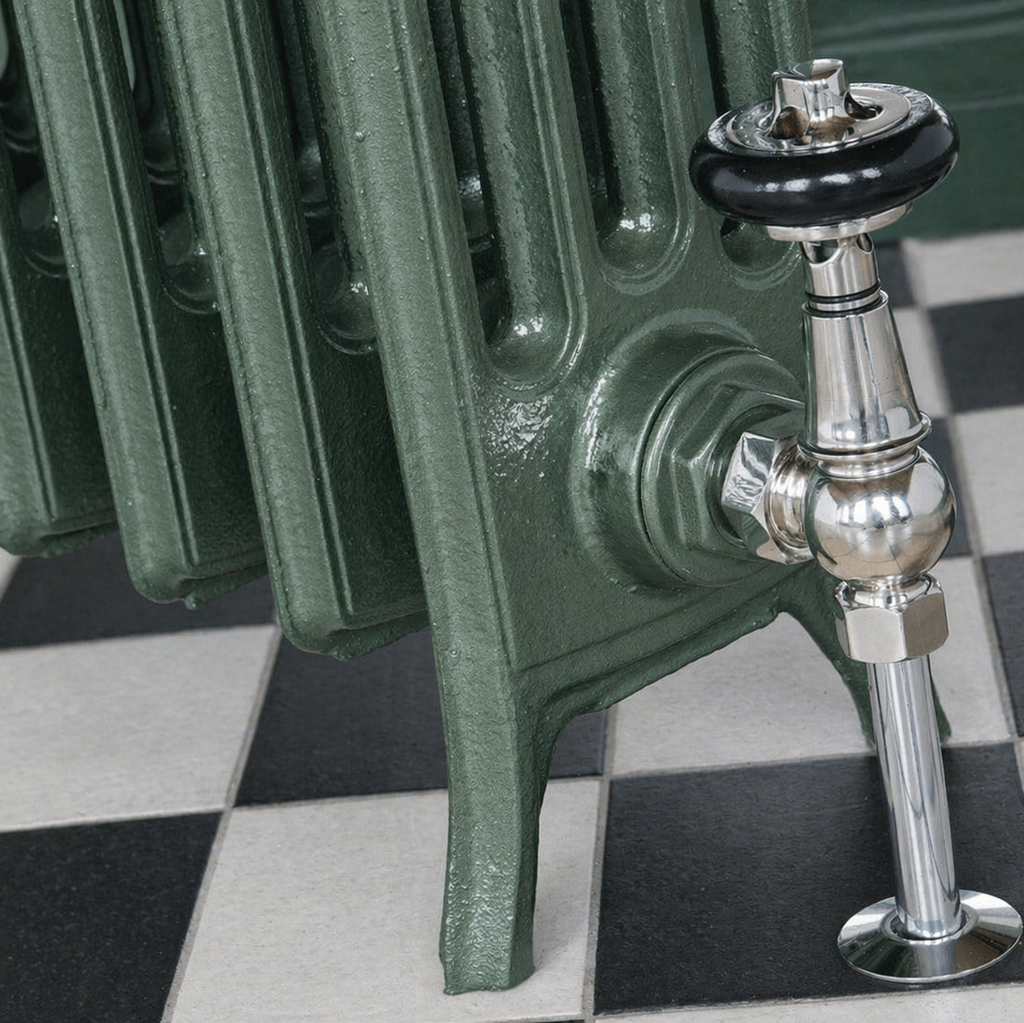 Green smoke cast iron radiator with chrome valve on a checkered floor