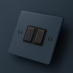 Hague Blue light switch with two black rocker buttons on a Hague Blue background