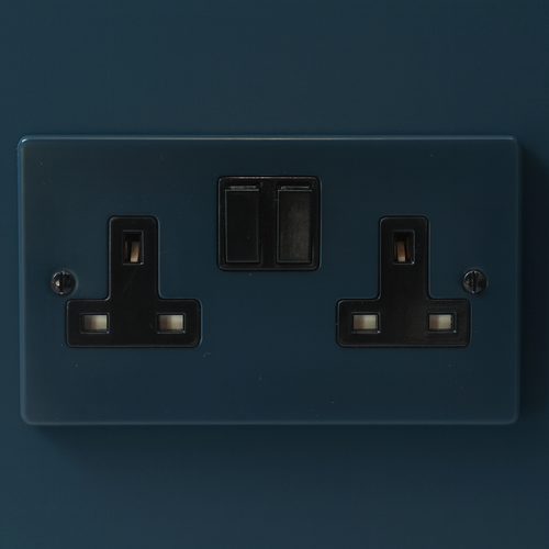 Hague Blue electrical socket with two sockets and a switch on a Hague blue background